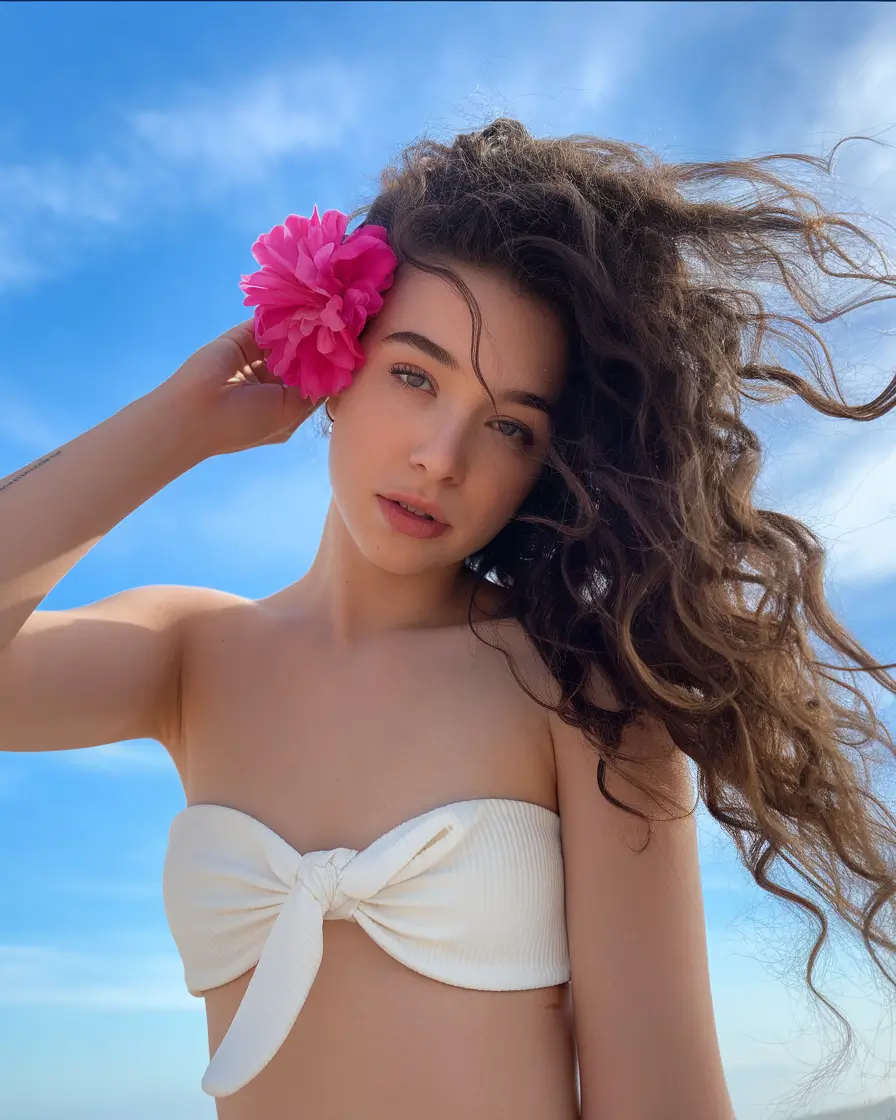 Practical Summer Swimming Hairstyles 2025 Loose Natural Curls with a Floral Pop