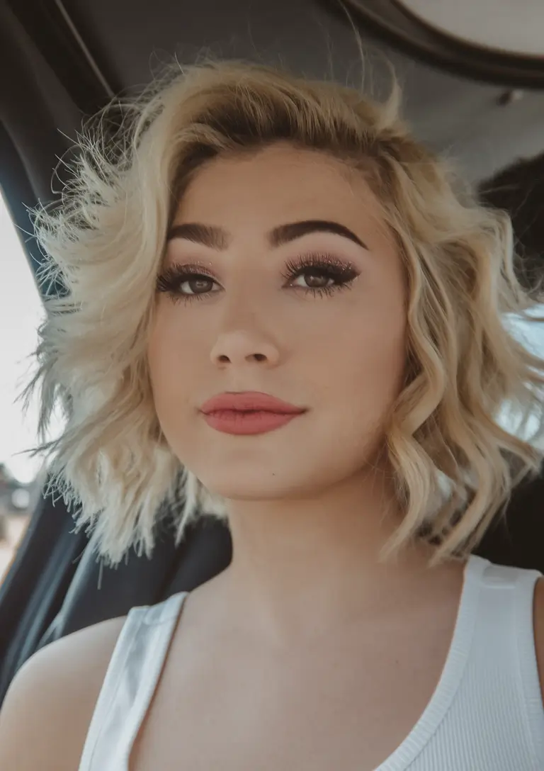 Summer 2025 Haircut Ideas for Round Faces - Playful Platinum Tousled Bob