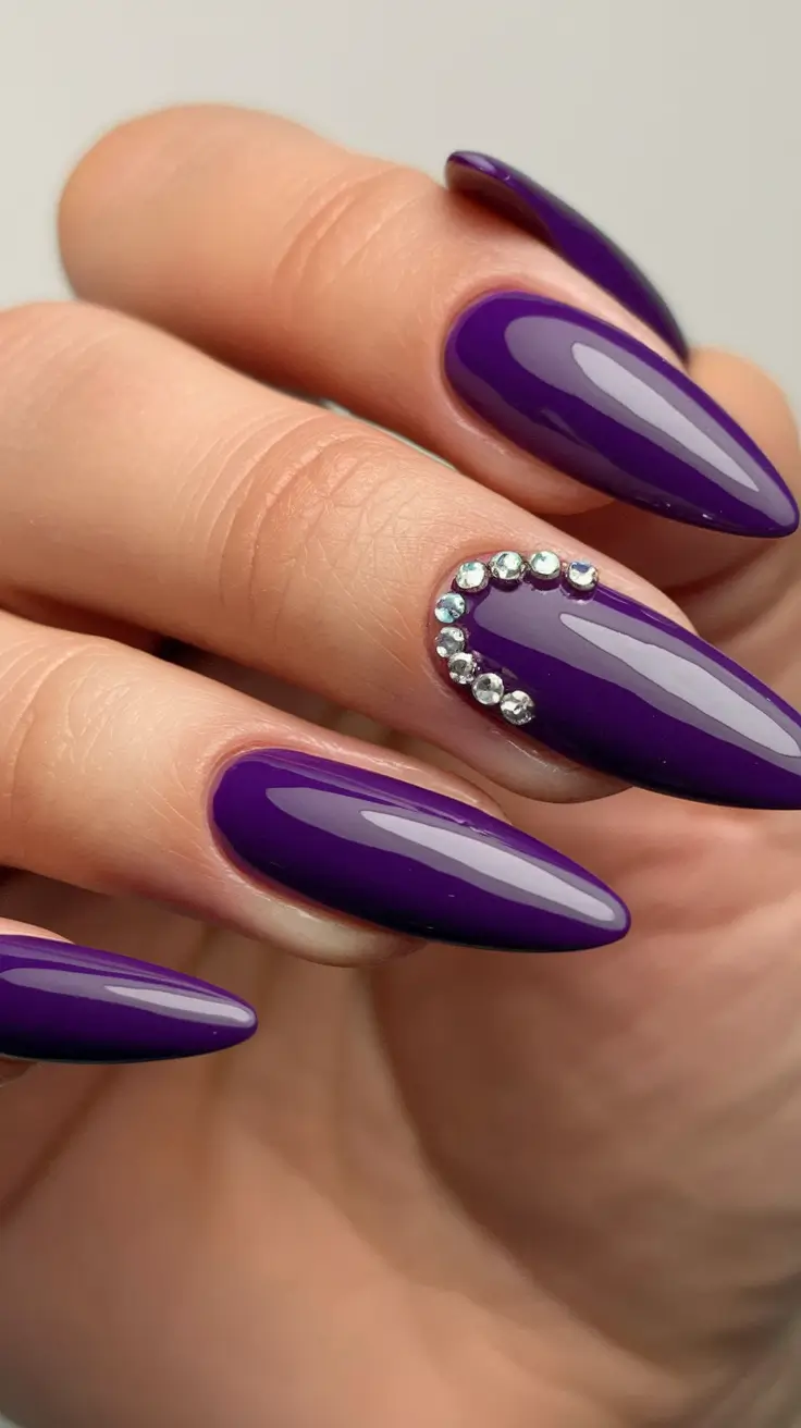 Long fall nails ideas 2025 Glossy Purple Almond Nails with Rhinestone Accent