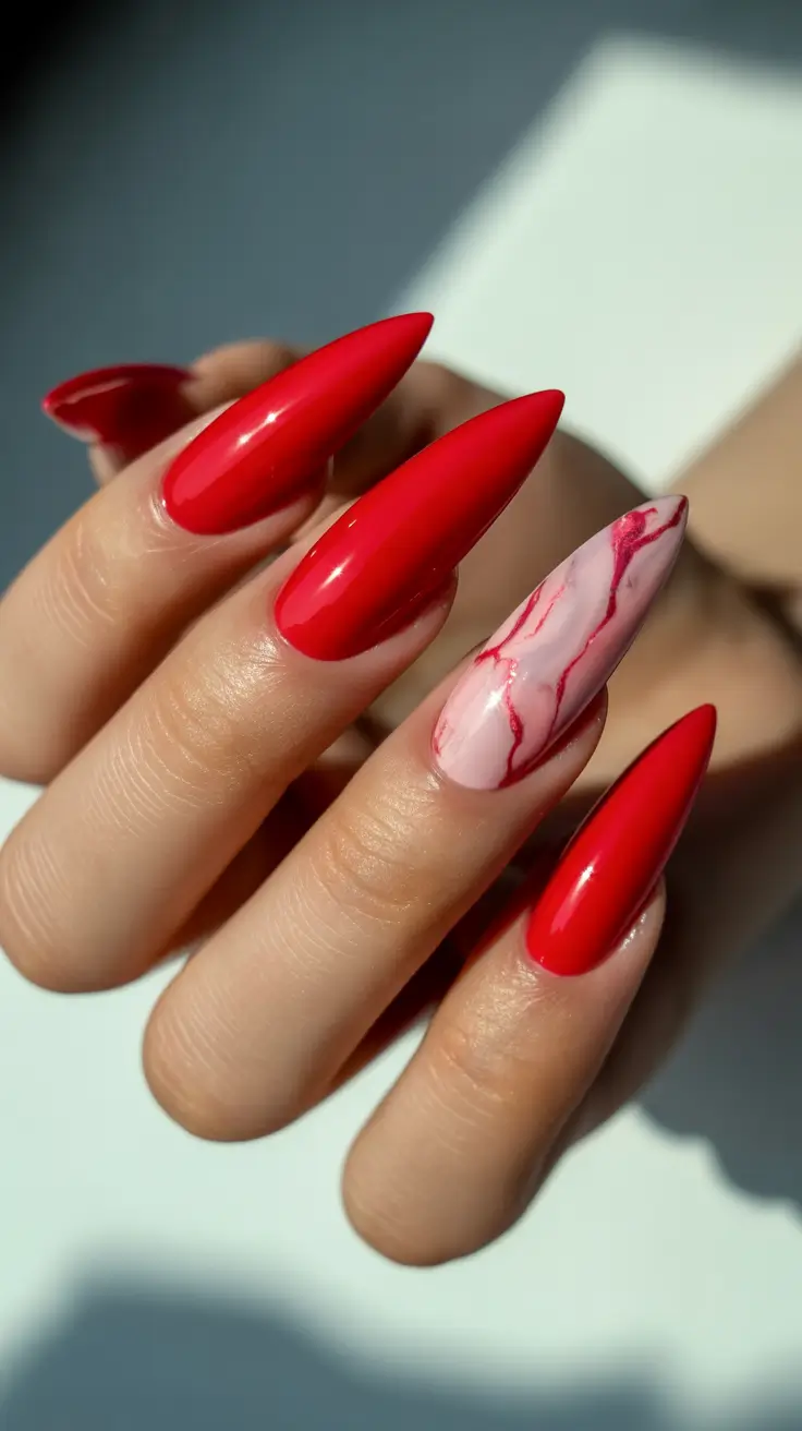 modern nail design 2026 Glossy Red With Marble Accent Flair