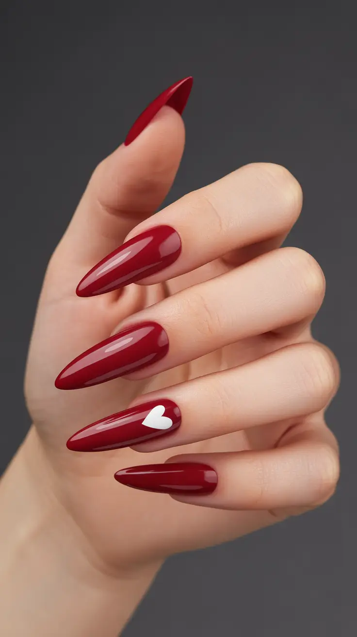 red nails 2026 Deep Red Almonds With a Cute Heart Detail