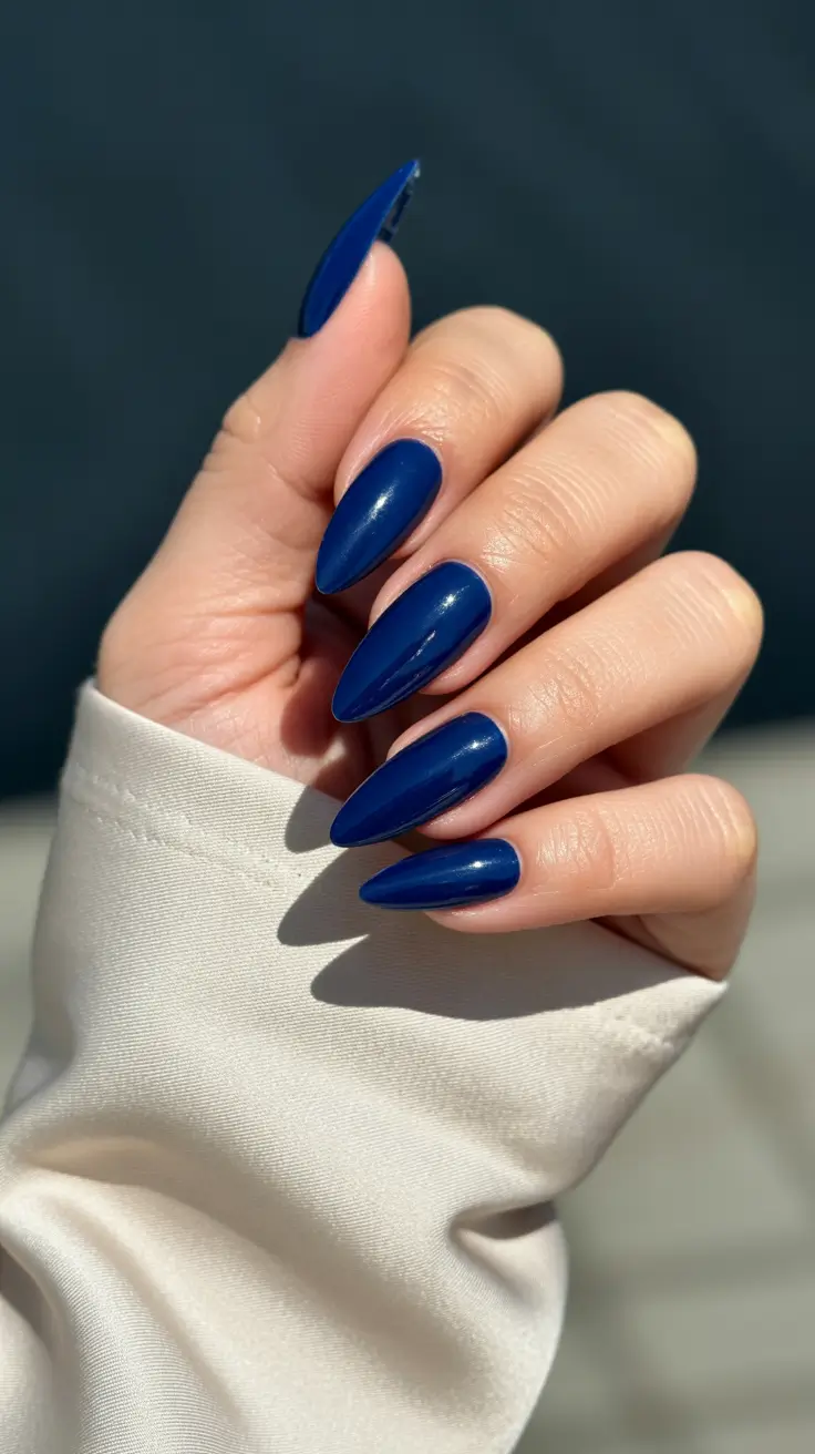 beach spring vacation nails 2026 Glossy Deep Blue Almond Nails That Feel Like Midnight by the Sea