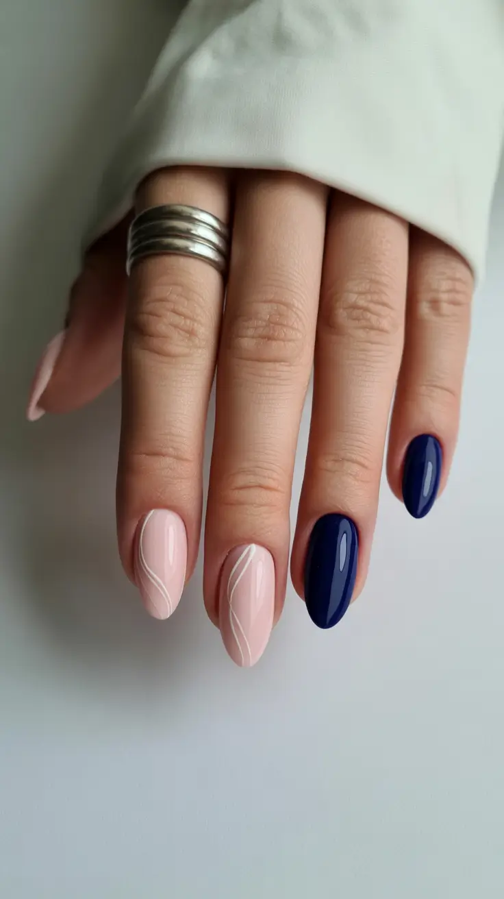sophisticated spring oval nails 2026 Nude Blush Minimalism with Midnight Blue Accent