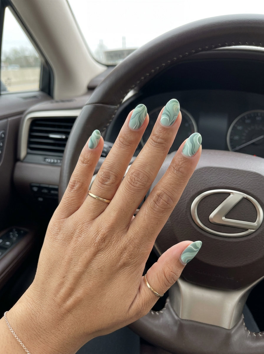 Oval summer nails 2026: Sage garden swirls for daily wear and festivals. Mint green, sage green, white marble.
