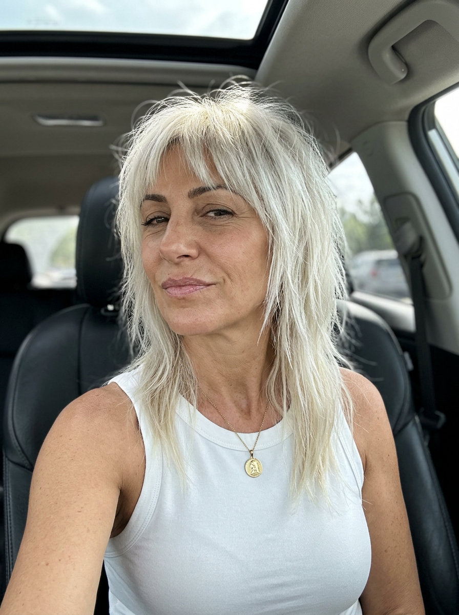 short platinum blonde shag haircut with choppy layers and full fringe for rebellious summer