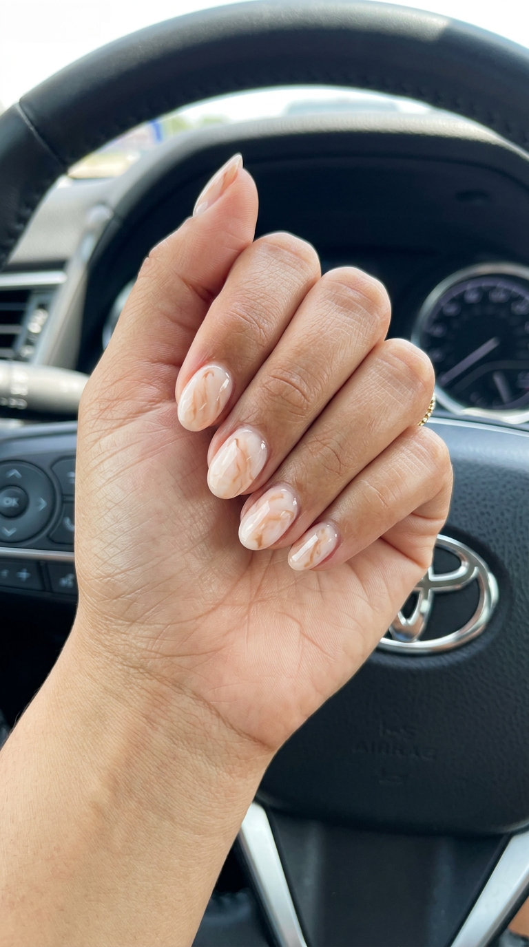 Marble Dream Short Oval Summer Nails 2026 Milky peach marble dream short oval nails, ideal for formal events and sophisticated looks. Short oval summer nails 2026.
