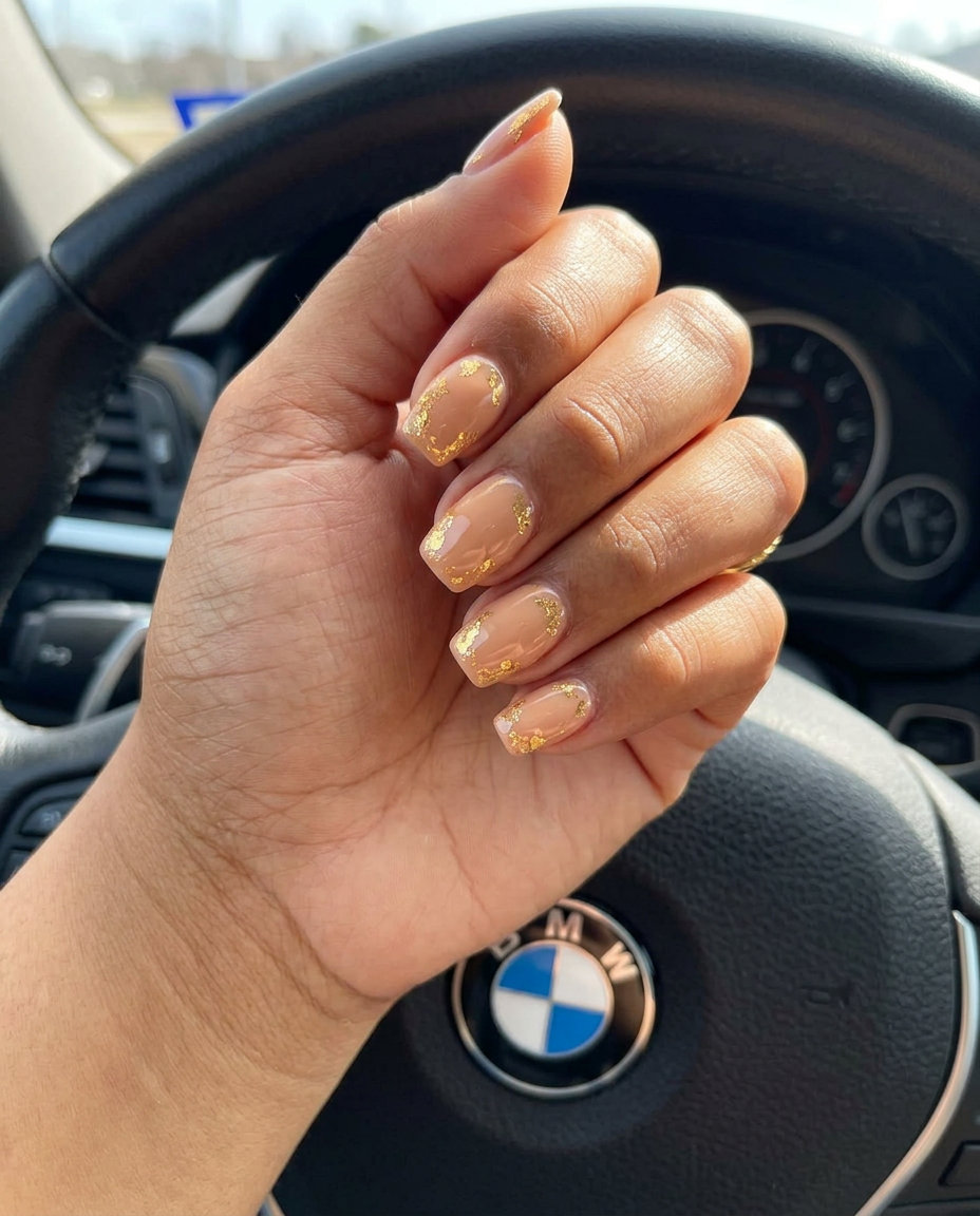 Short Summer Nails 2026: Gilded Nude Elegance Short summer nails 2026: Elegant warm nude with scattered gold foil flakes for sophisticated workwear.