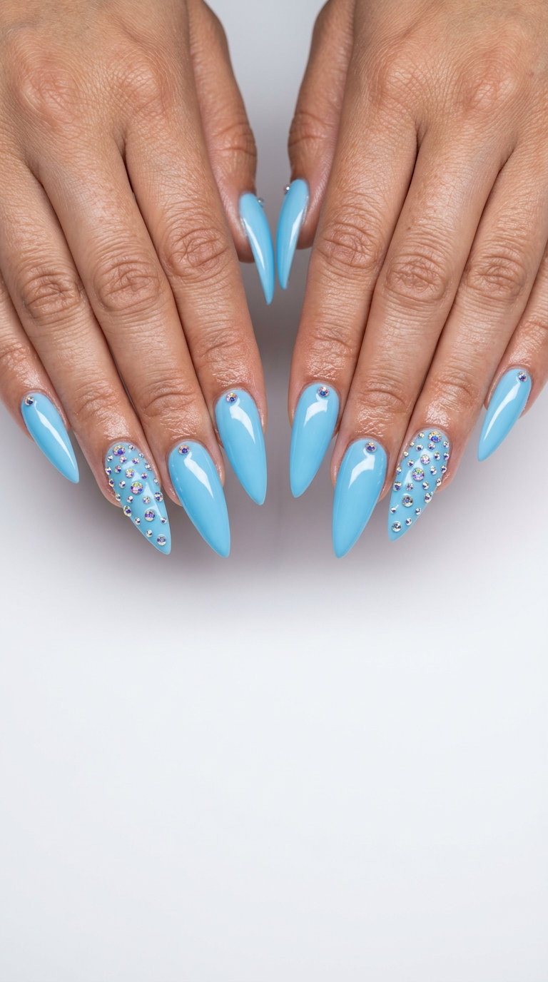 Ocean Sparkle Stiletto nails: Glamorous light blue acrylics with iridescent rhinestones for vacation & parties. Simple summer acrylic nail designs 2026.