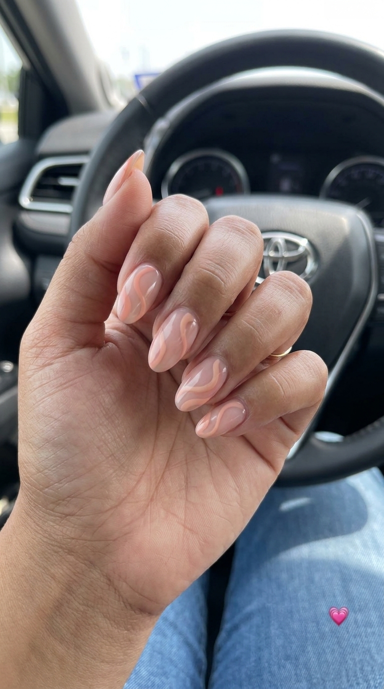 Sheer peach abstract swirls medium nails for simple summer nails 2026. Bohemian and relaxed for vacations.