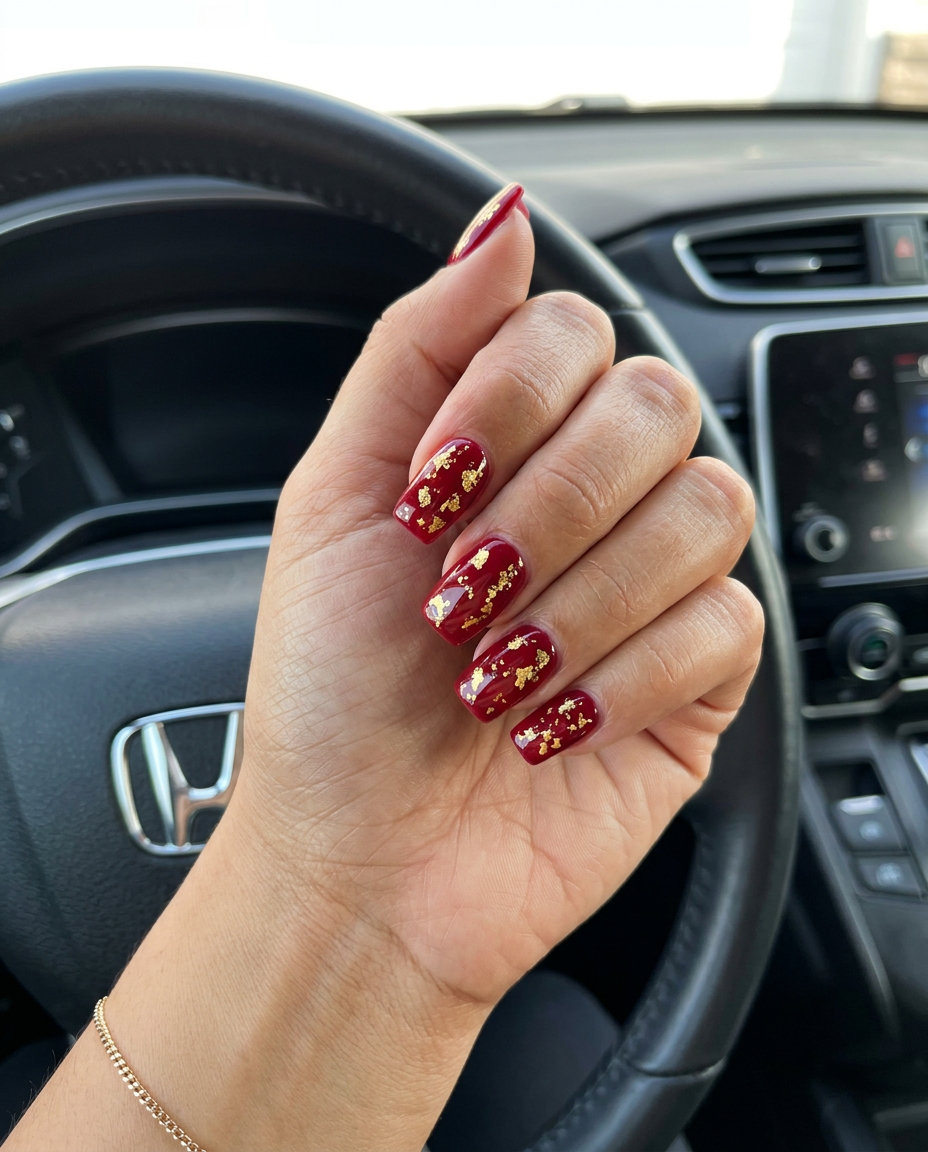 Event Nails 2026: Red & Gold Foil Luxurious deep red nails with scattered gold foil for summer events 2026.