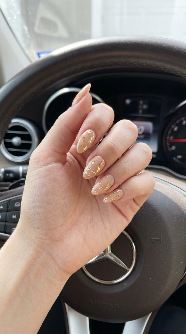 Trending Summer Nails 2026: Glamorous Gold Foil Almond Trending summer nails 2026: Golden hour foil almond nails for a glamorous party or evening event.