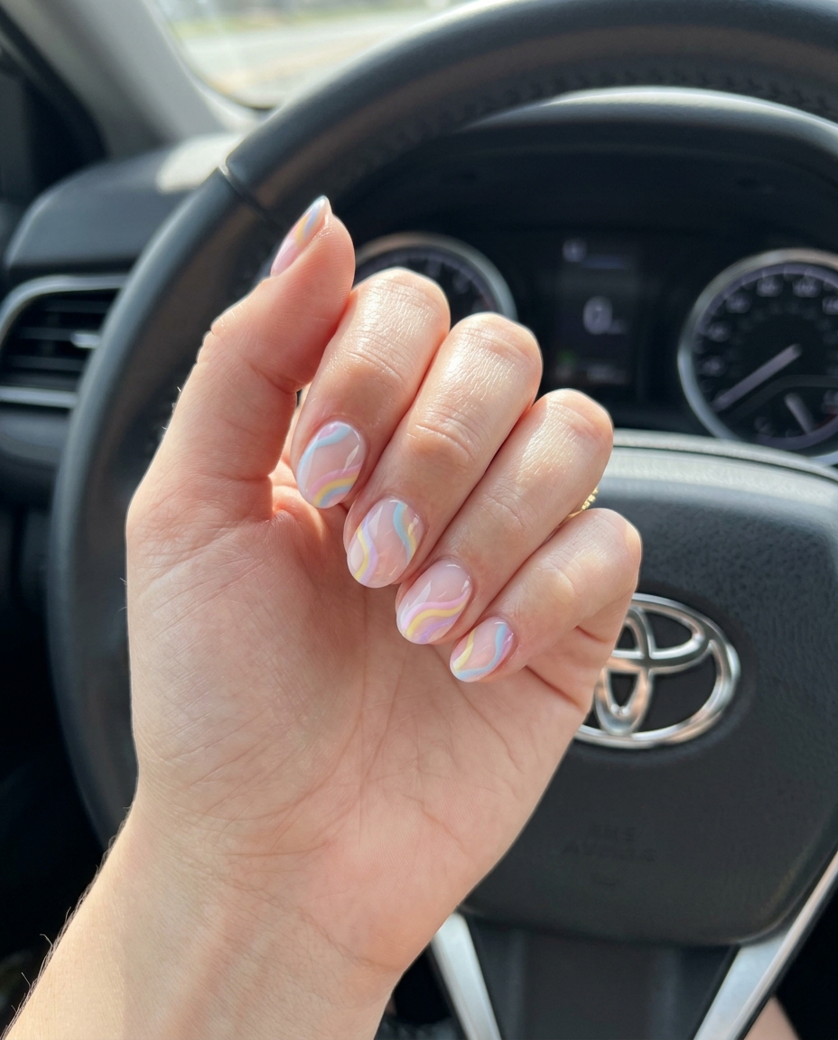 Trending summer nails 2026: Pastel rainbow swirl short round nails for a playful, whimsical festival look.