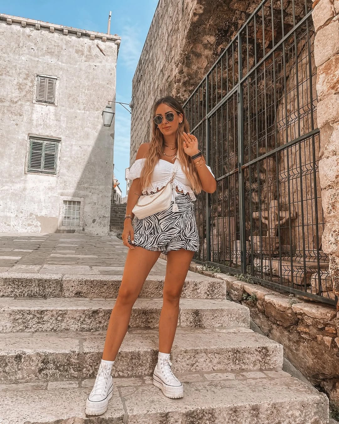 august outfits 2026 White Eyelet Tops and Zebra Shorts Make the Ultimate Vacation Combo