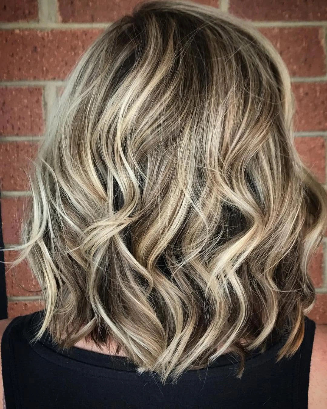 body waves hairstyle Textured Blonde Waves on a Modern Short Bob