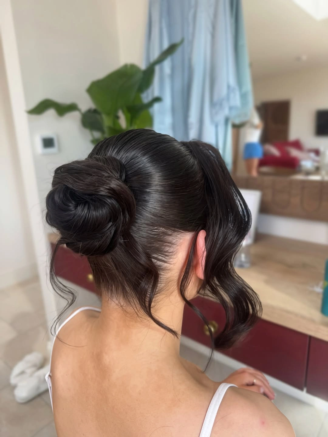 bridesmaid hairstyling Minimalist Sleek Bun with Face-Framing Waves