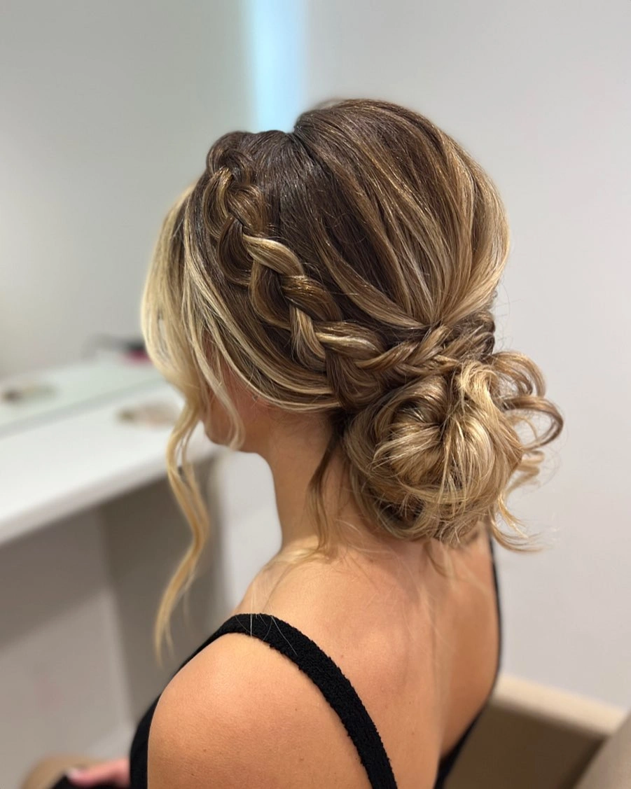 bridesmaid hairstyling Braided Low Bun with Soft Romantic Texture
