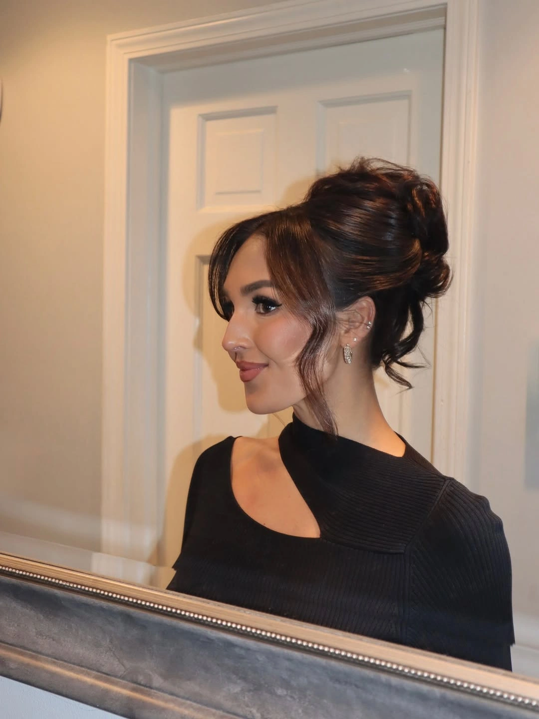 bridesmaid hairstyling Elegant High Bun with Soft Curtain Bangs