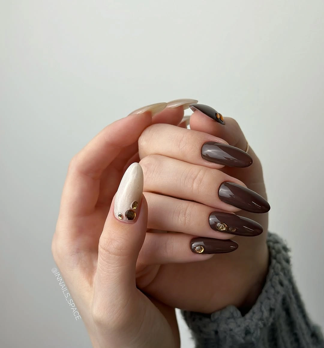 chocolate almond nails with gold accent studs