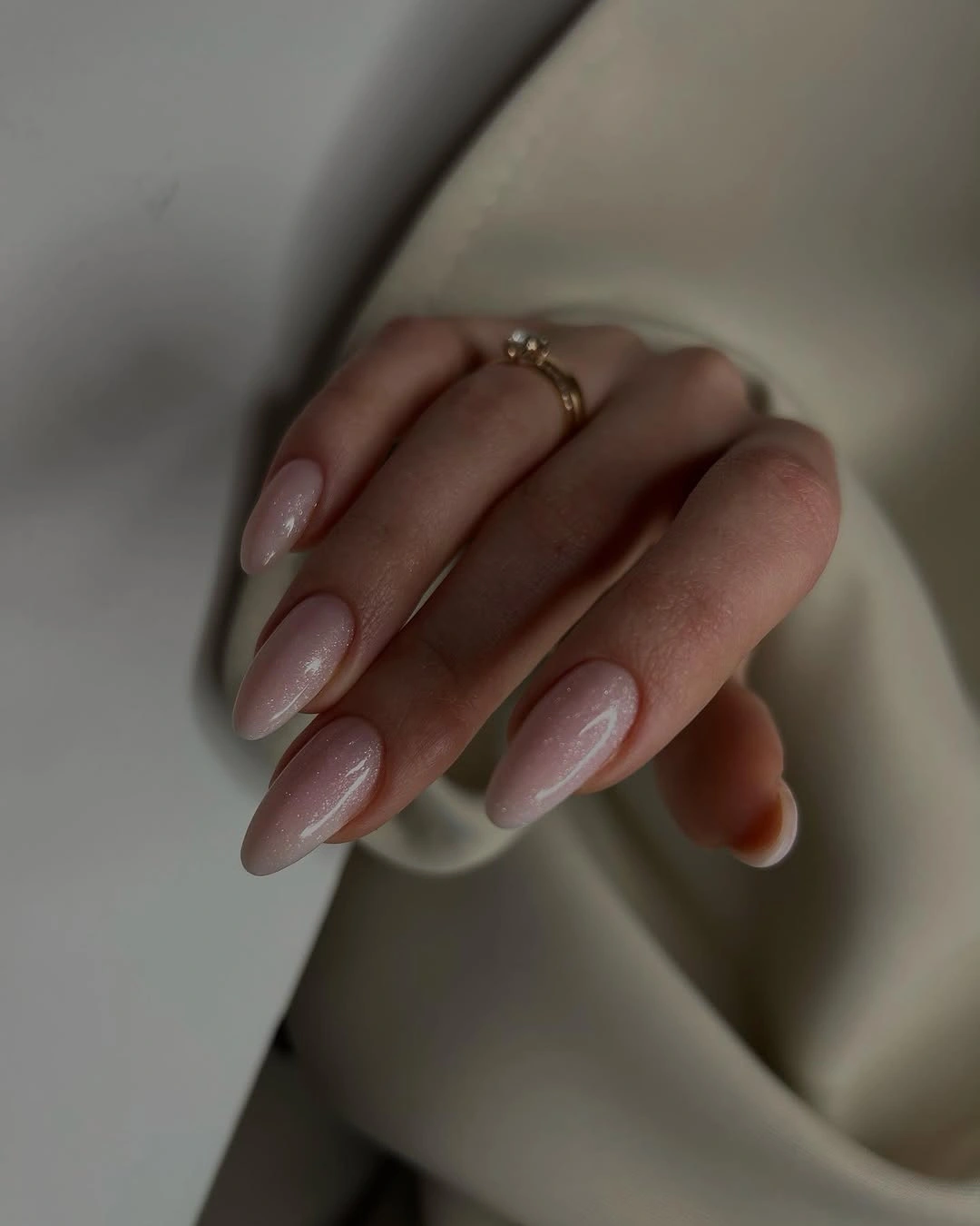 shimmery nude almond nails with fine sparkle