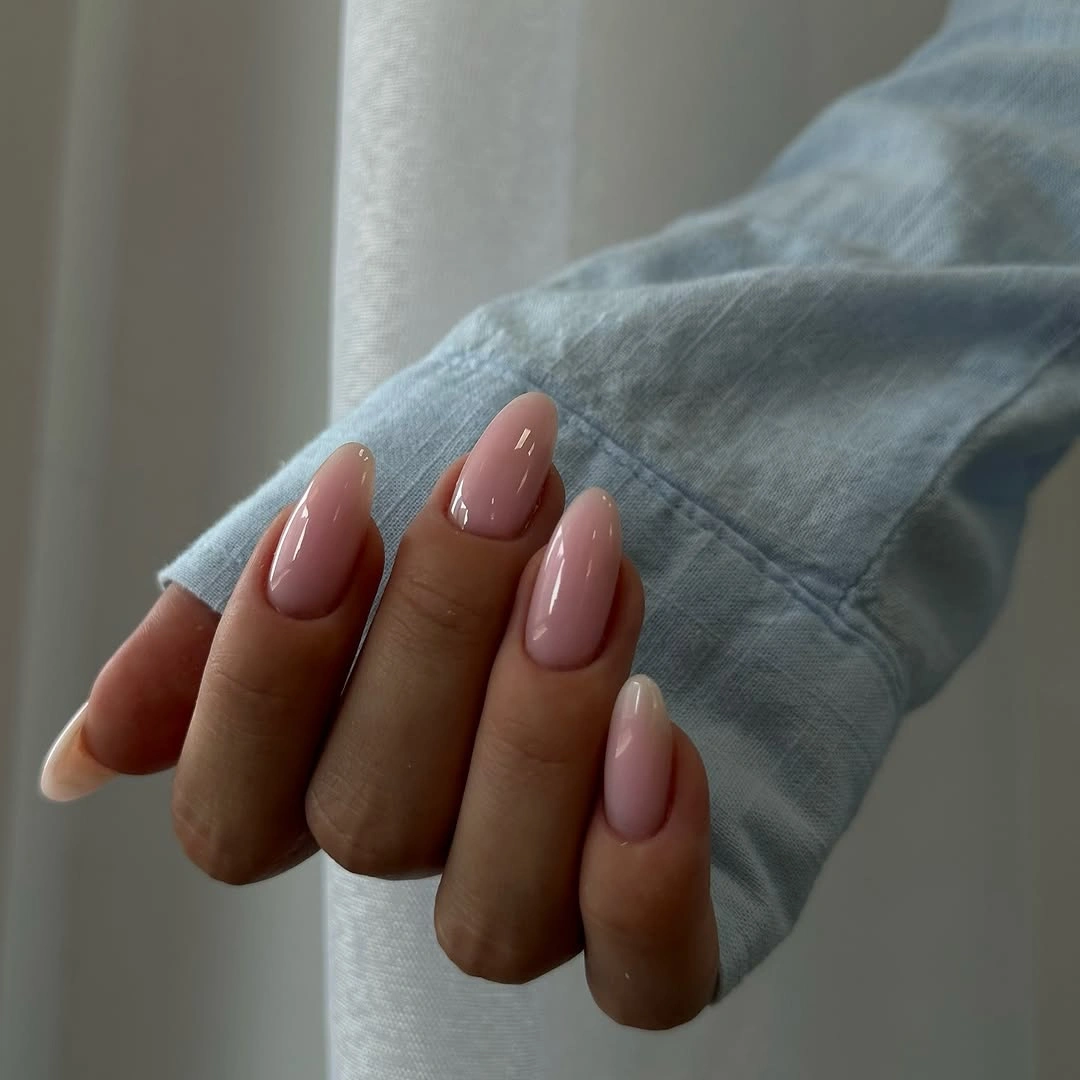 glossy pink almond nails with creamy pale ends