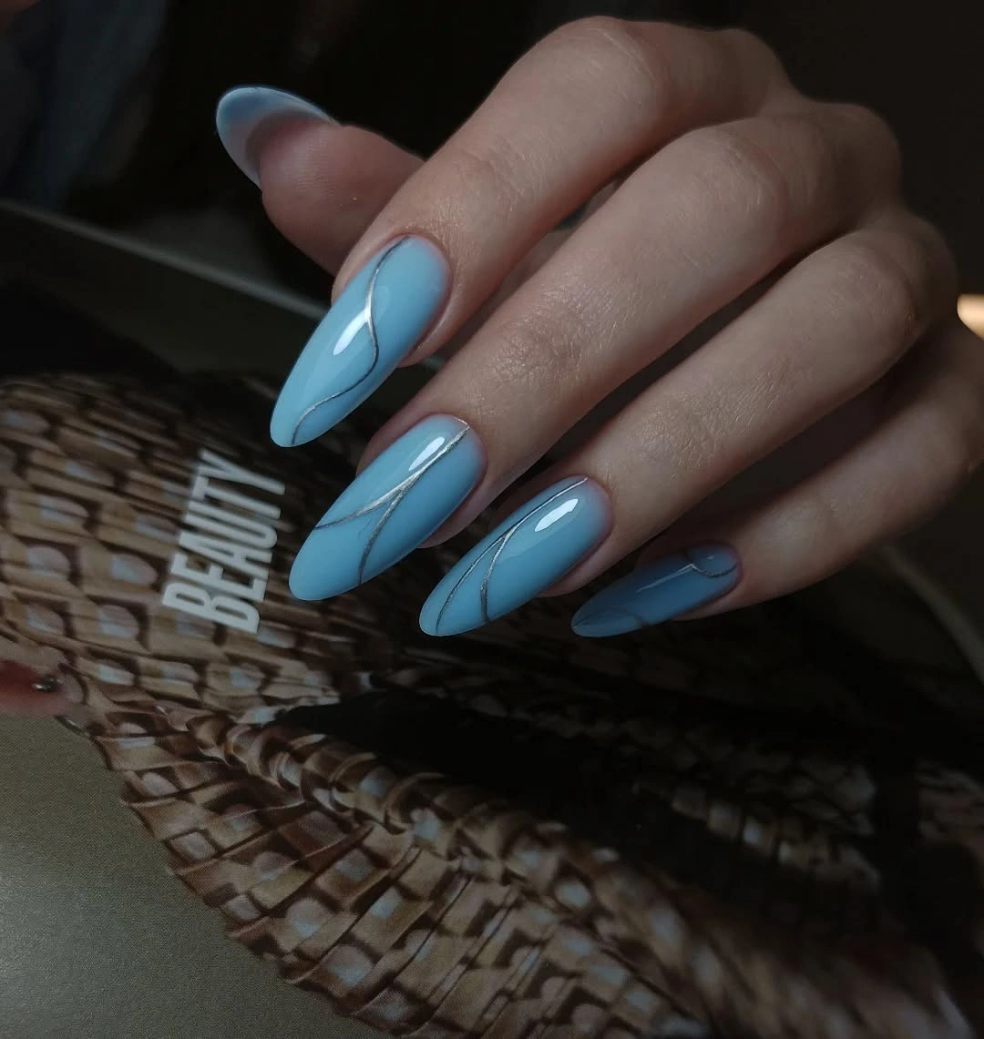 icy blue almond nails with silver curved lines
