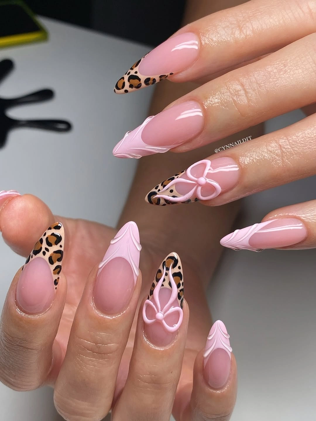 leopard French almond nails with pink bow details