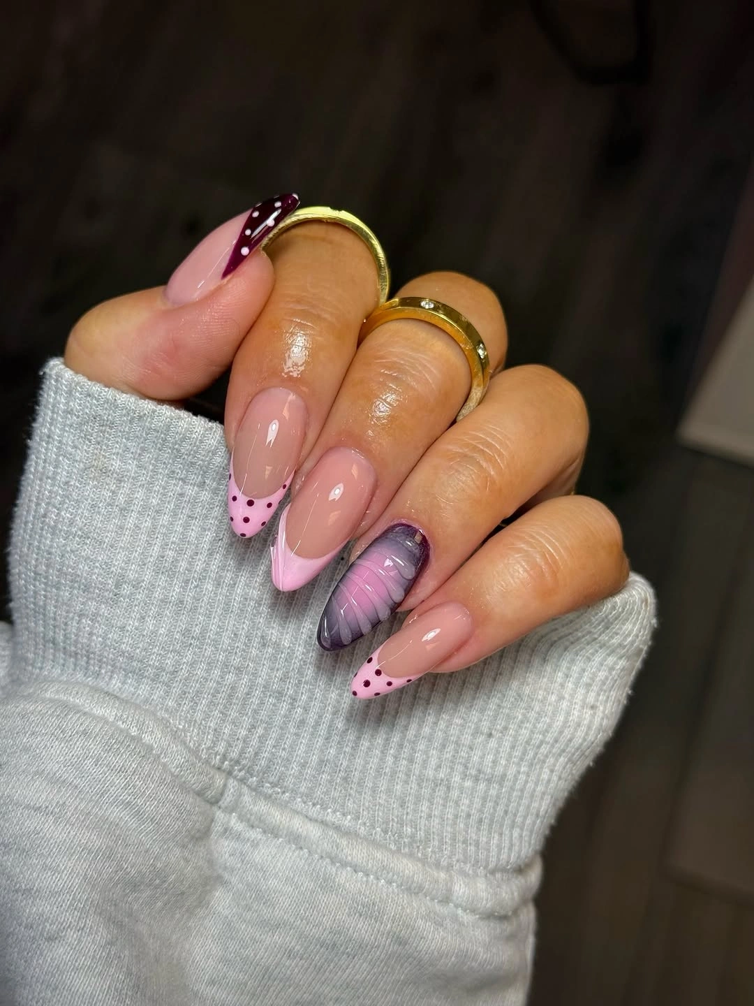 pink French almond nails with plum polka dots