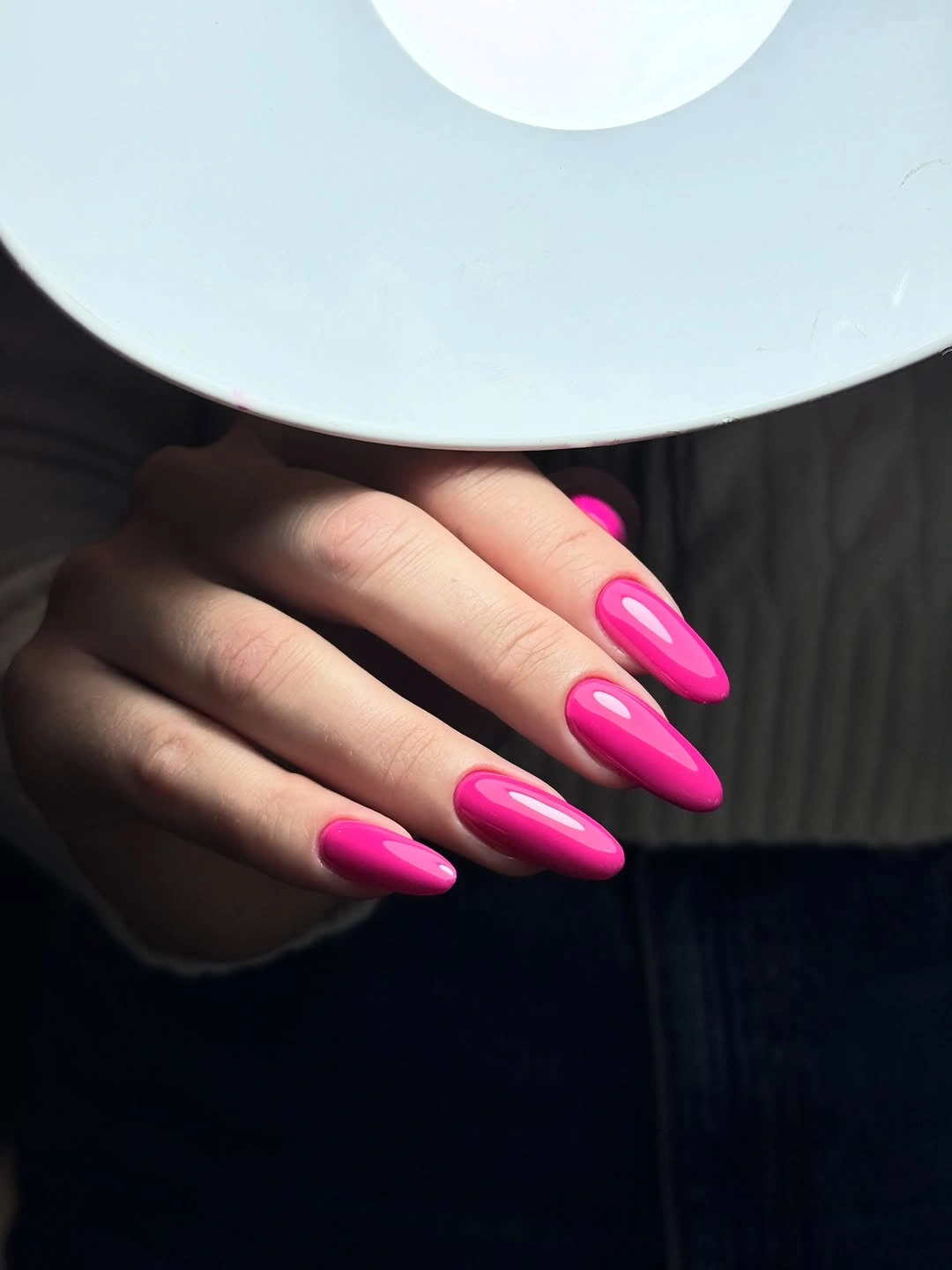 glossy hot pink almond nails on hand