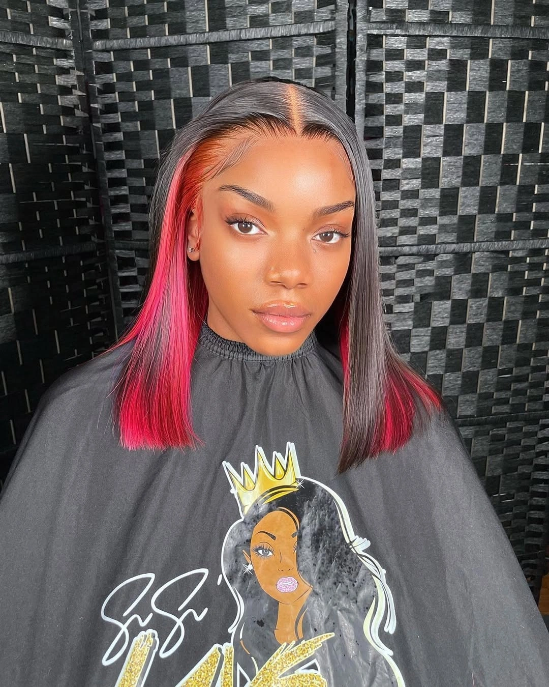 fall hair colors for black women 2026 Black Bob with Bold Crimson Peekaboo Panels