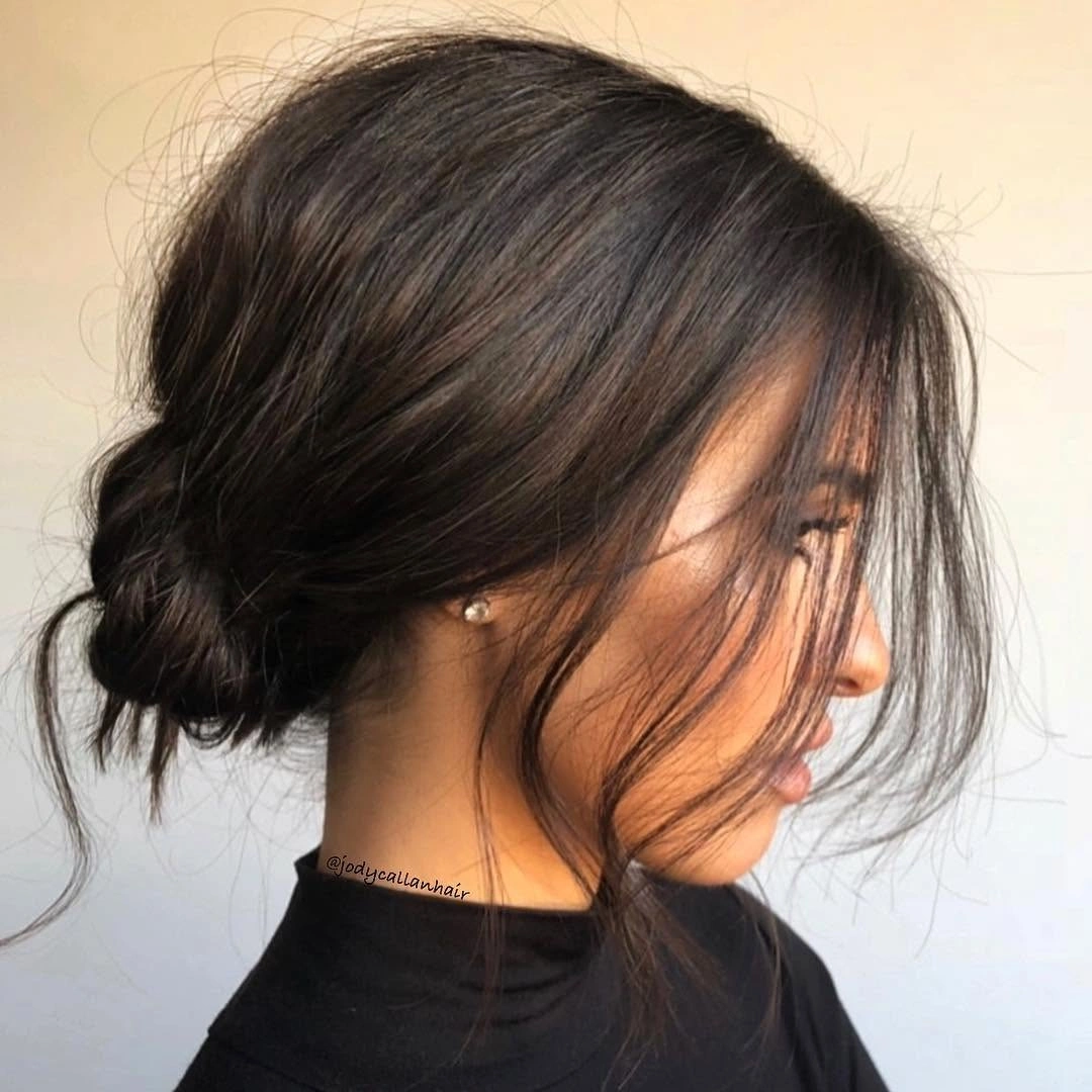 Fall hairstyles for office 2026 Soft Textured Low Bun With Face-Framing Layers