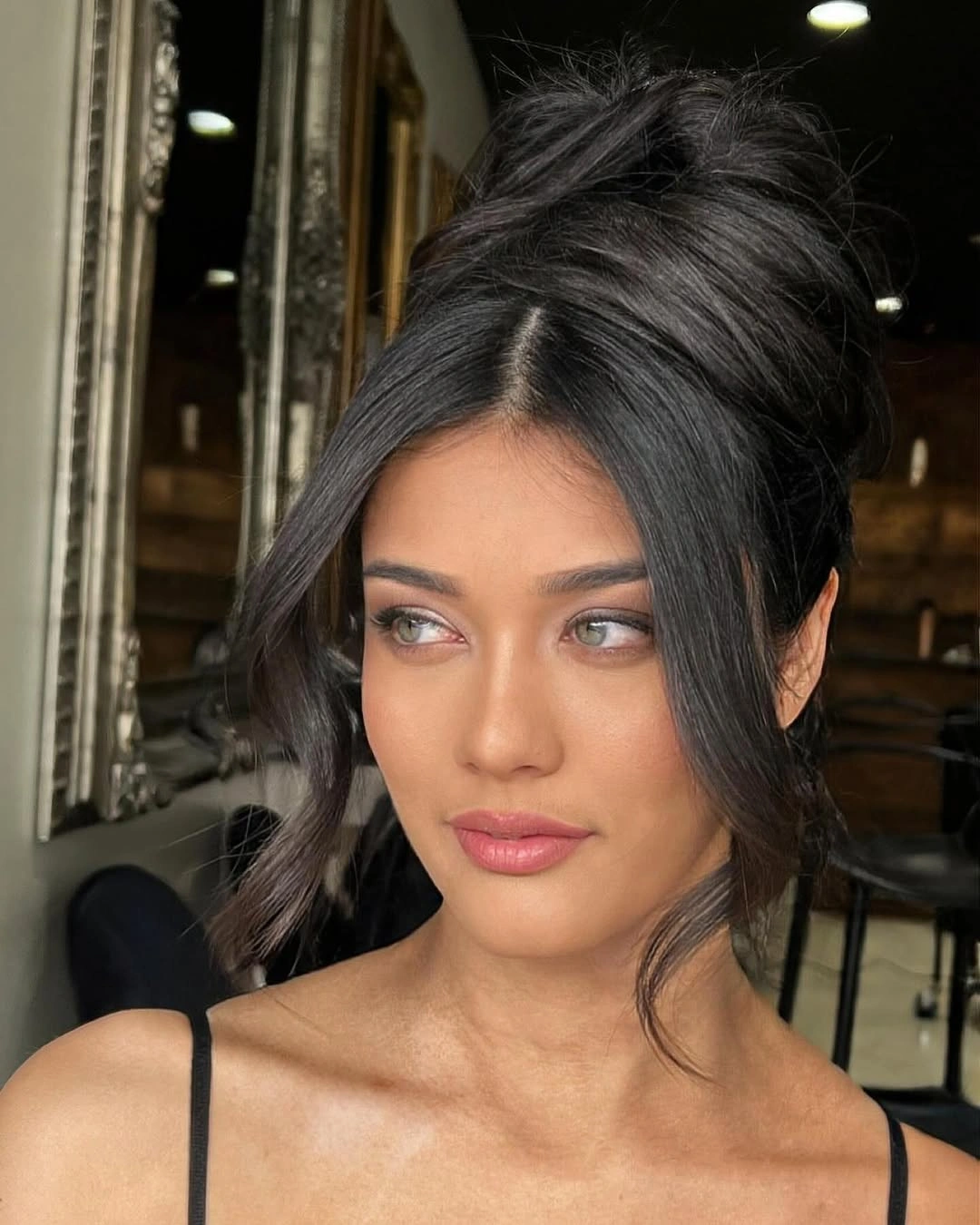 Fall hairstyles for wedding guests 2026 Relaxed High Bun with Curtain Strands for Modern Elegance