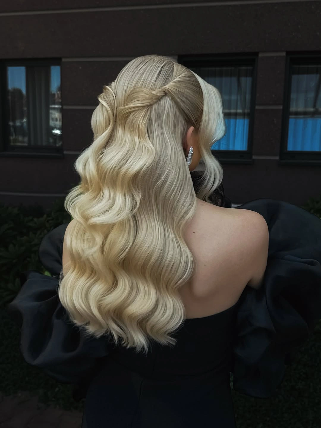Fall hairstyles for wedding guests 2026 Half-Up Platinum Waves with Elegant Twisted Details