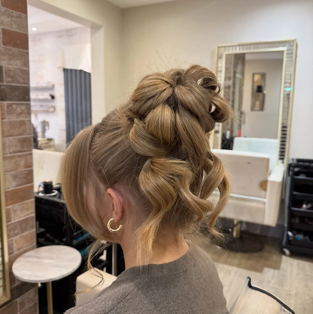 Fall hairstyles for wedding guests 2026 Textured Twisted Updo with Playful Face-Framing Pieces