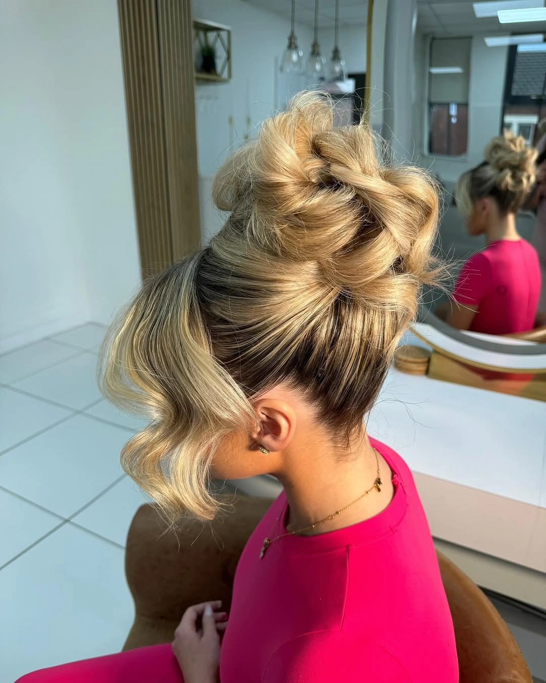 Fall hairstyles for wedding guests 2026 Voluminous Twisted Bun That Feels Like Autumn Romance