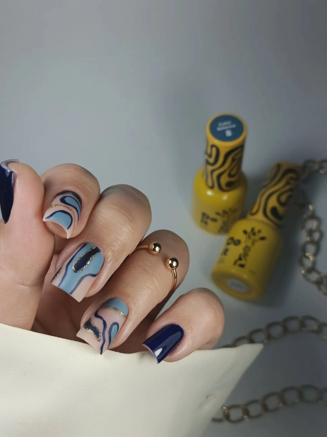 navy and blue square nails with abstract curved panels