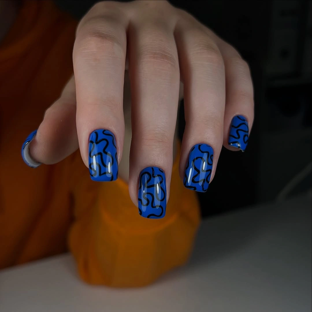 cobalt blue square nails with abstract black squiggle lines