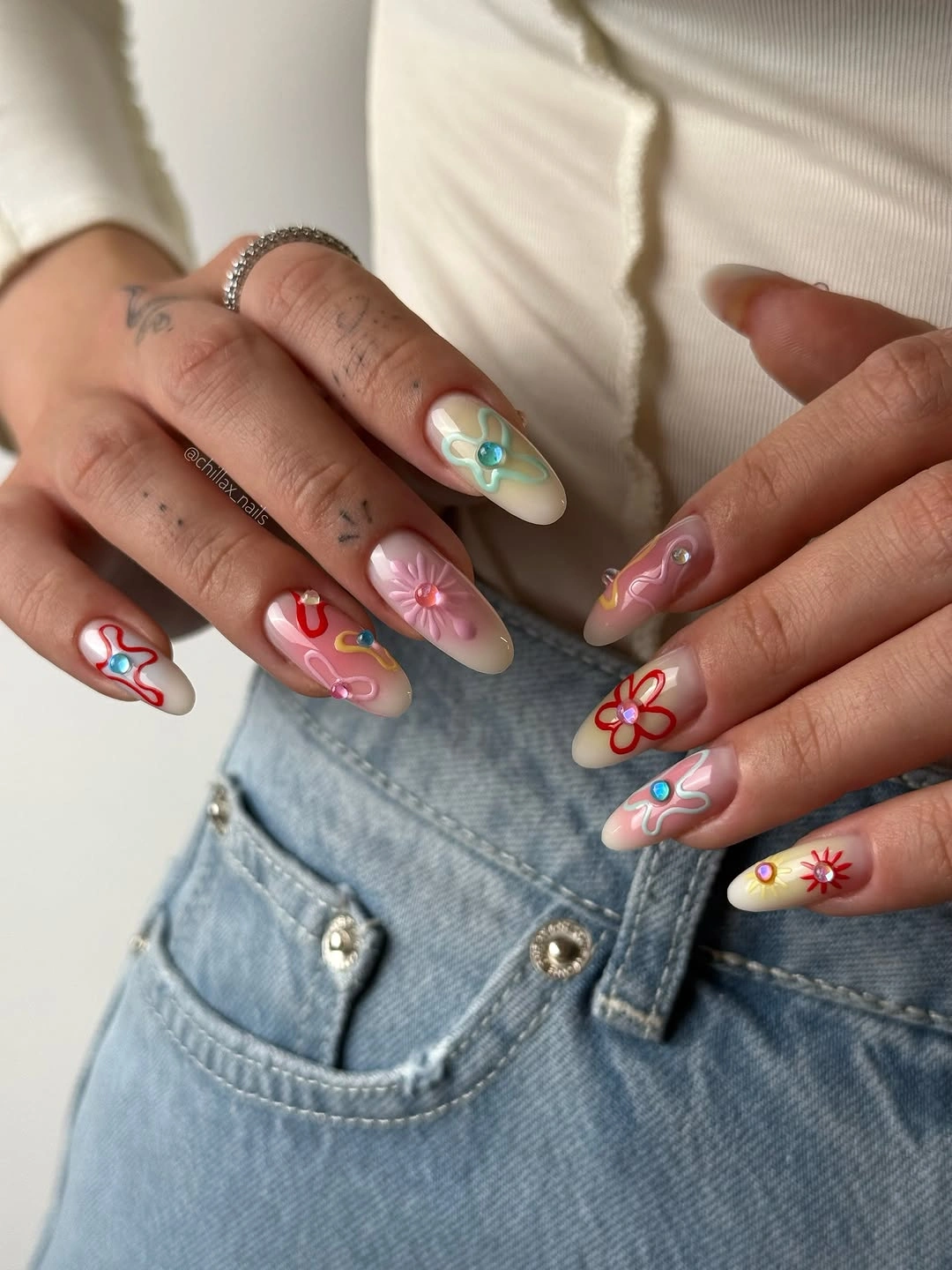 Fall nail art 2026 Multicolor Floral Nail Art on Long Almond Nails