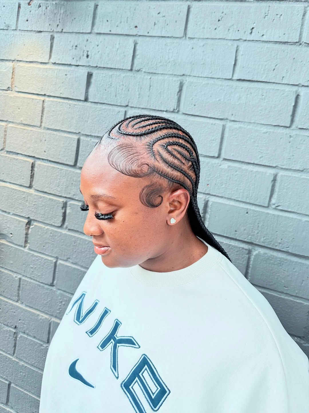 feed in braid hairstyles Elegant Swirl Feed-In Braids with a Sleek Low Finish