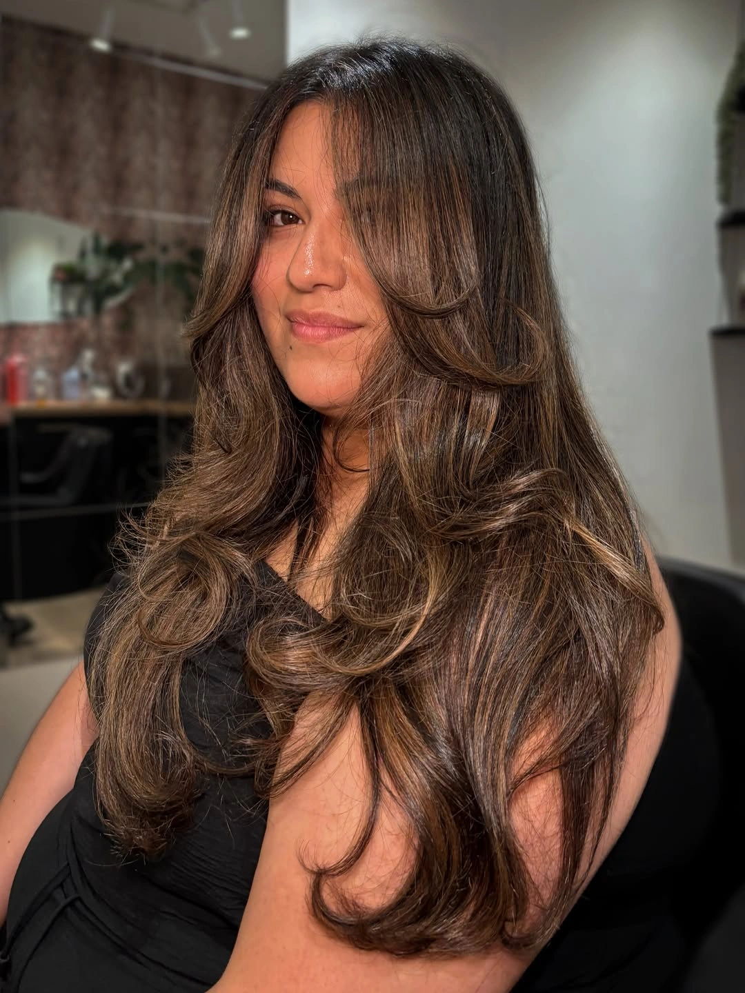 Hair Lowlights: Color Ideas and Inspiration Chocolate Brunette Lowlights with Glossy Cascading Layers