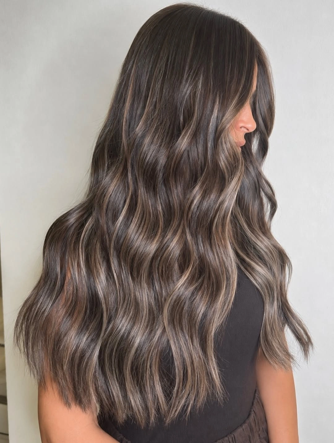 Hair Lowlights: Color Ideas and Inspiration Smoky Brunette Waves with Delicate Ash Lowlight Dimension