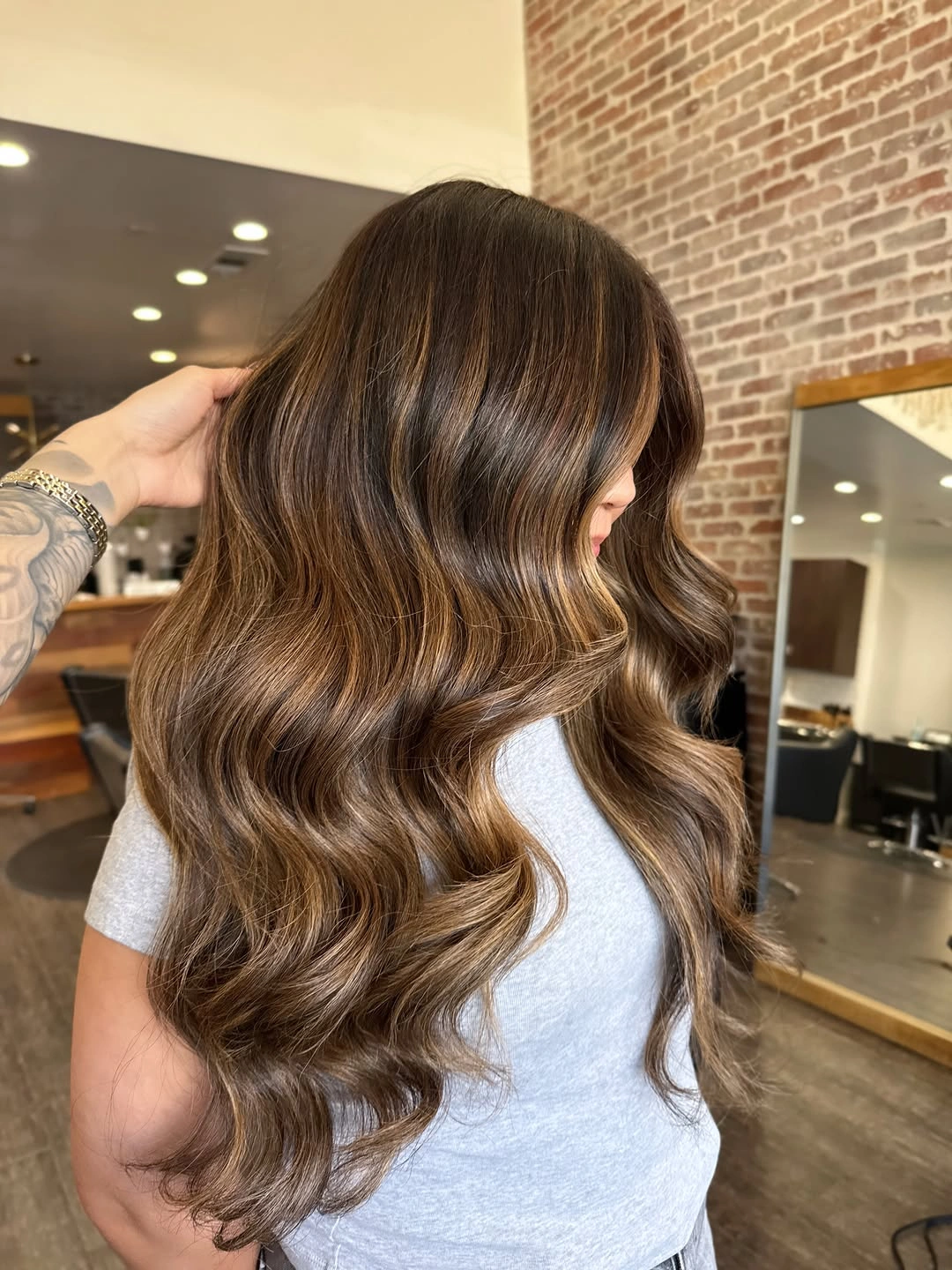 Hair Lowlights: Color Ideas and Inspiration Warm Caramel Lowlights That Make Long Waves Glow