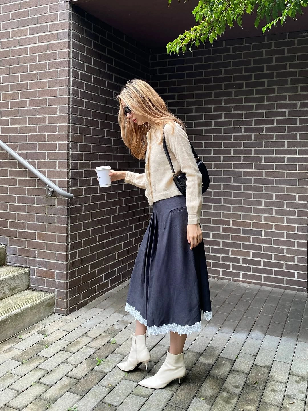 midi skirt fall outfit 2026 Grey Midi Skirt With Cozy Knit And White Boots