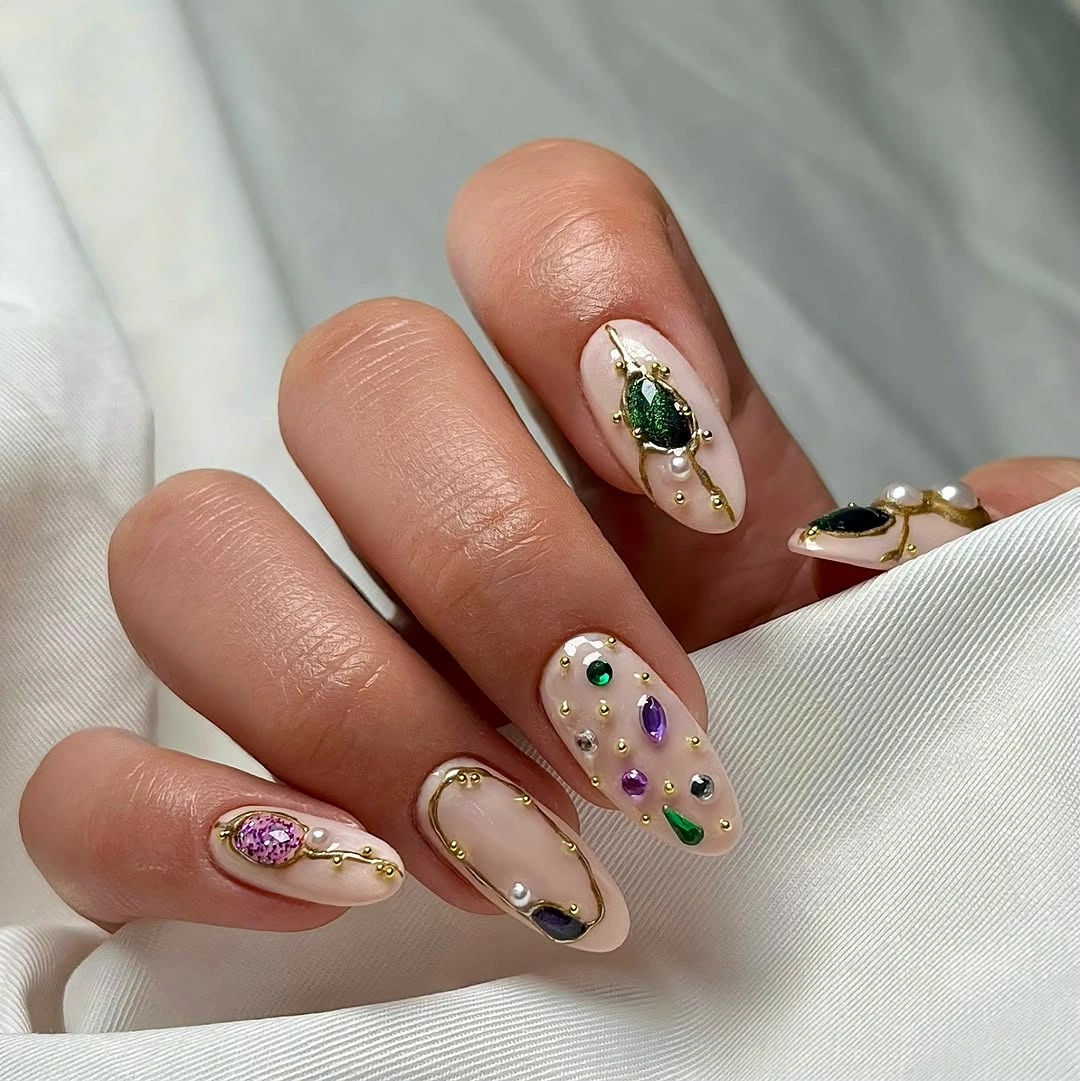 September nail art ideas 2026 Nude Almond Nails With Dots Gold Lines And Leaf Detail