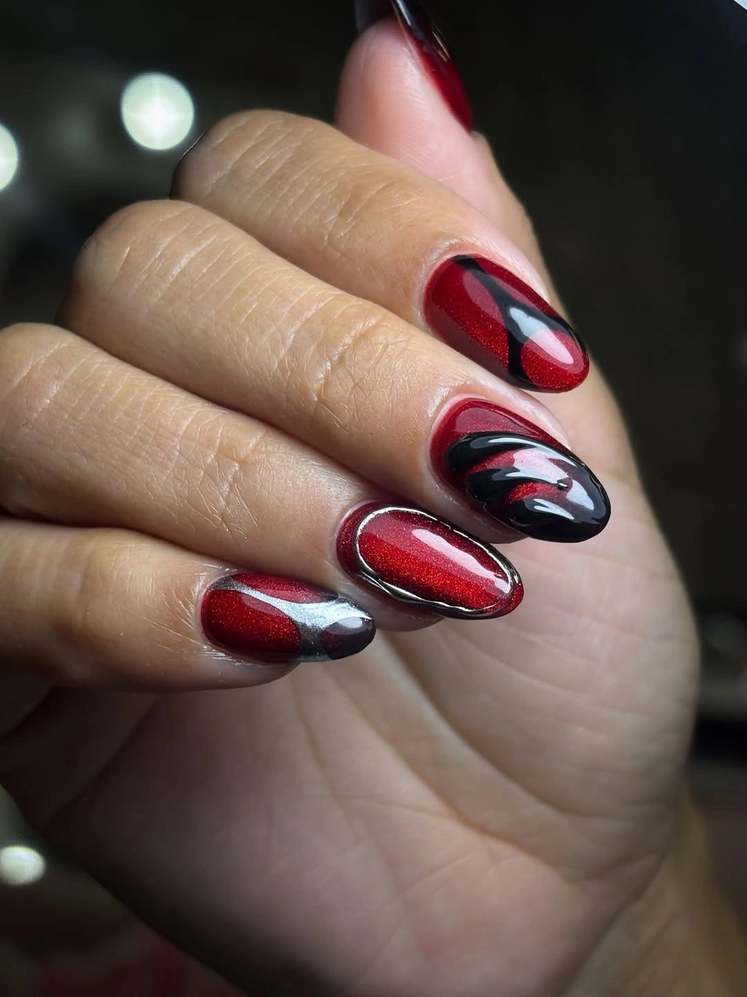 September nail designs 2026 Red Black And Silver Swirl Almond Nails