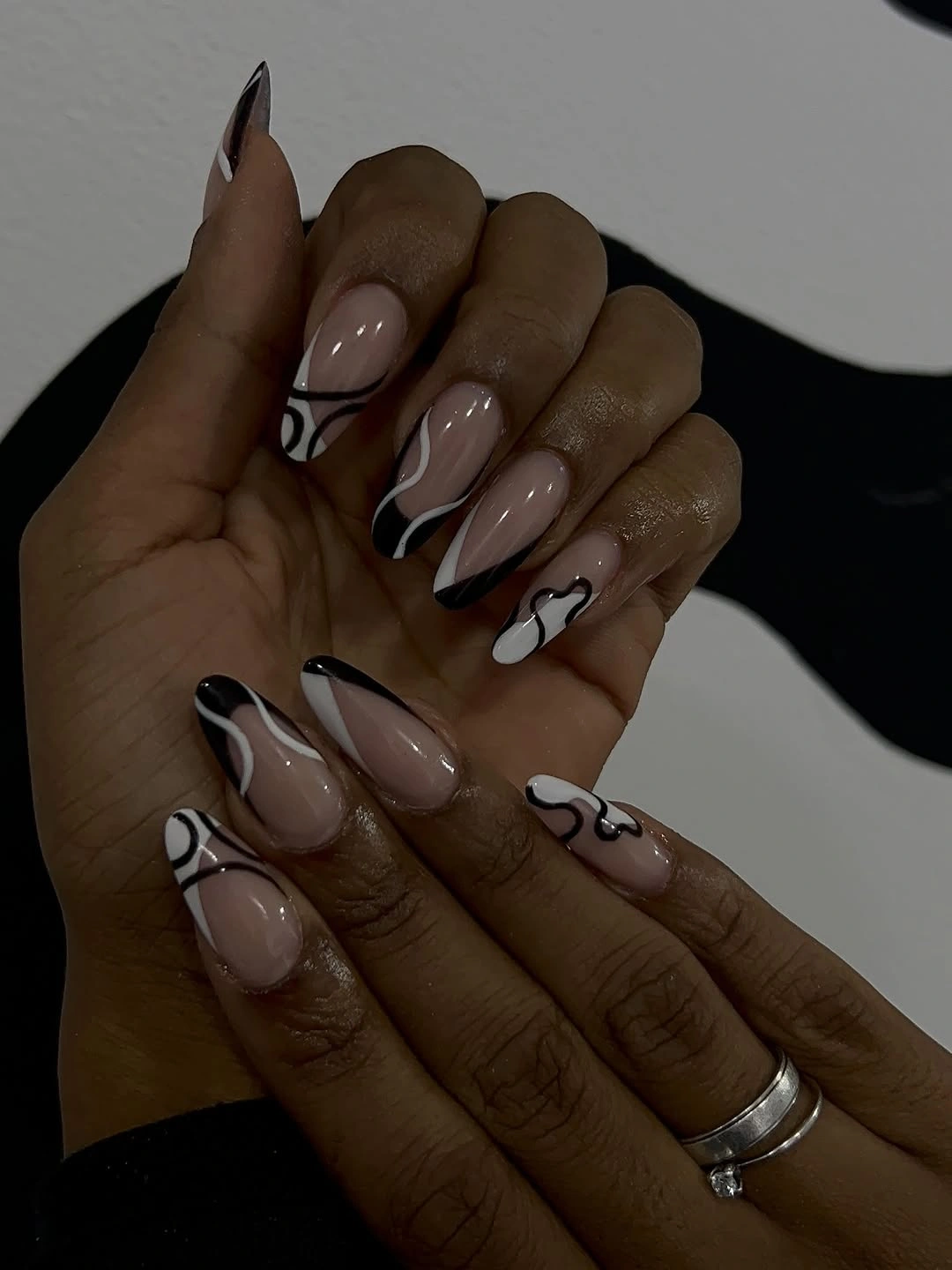 September nail designs 2026 Nude Almond Nails With Black White Flower Outlines