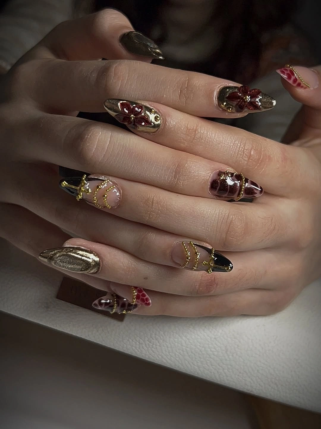 September nail designs 2026 Baroque Burgundy Nails With Gold Charm Accents