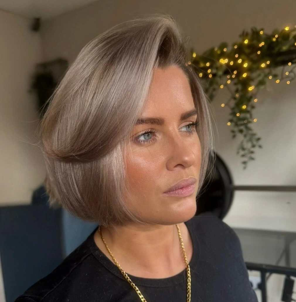 short bobbed hairstyle Elegant Champagne Bob with Sweeping Volume