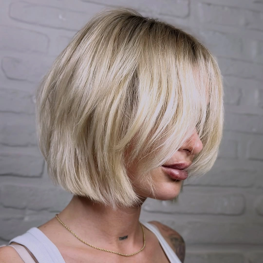 short bobbed hairstyle Bright Blonde Bob with Airy Curtain Bangs