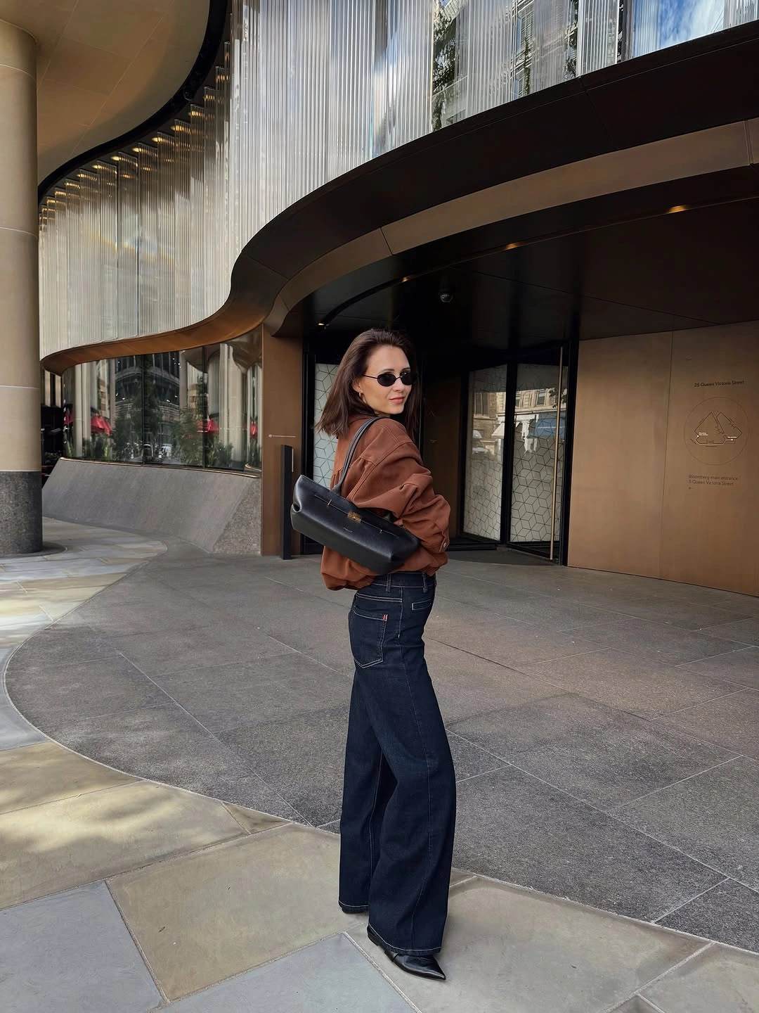 wide leg jeans outfit fall 2026 Brown Layers And Dark Denim With A Modern City Feel