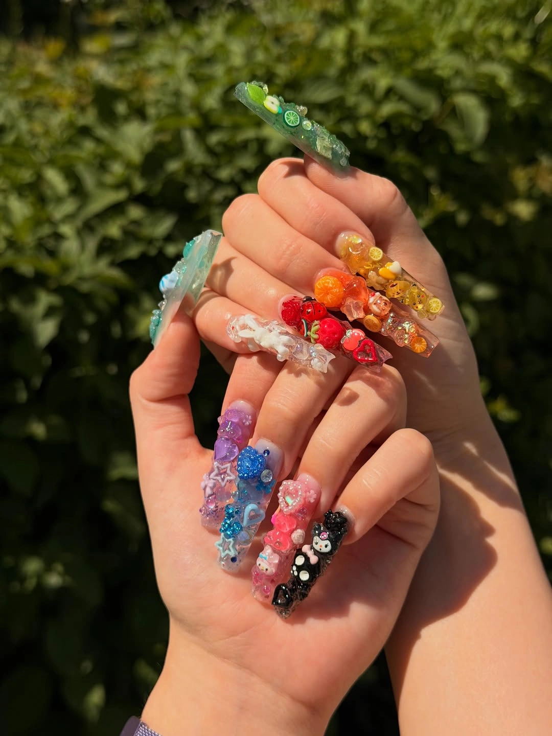 very long colorful stiletto nails with flowers beads and glitter
